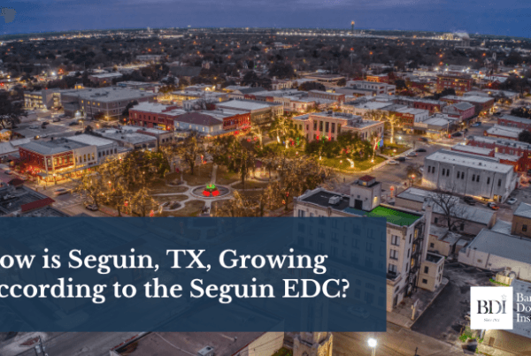 Aerial view of downtown Seguin, Texas, lit up at night, showcasing the city’s growth and vibrant community.