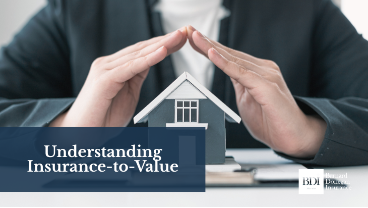 Person's hands protecting a model house, emphasizing understanding of insurance-to-value, with Donegan Insurance branding.